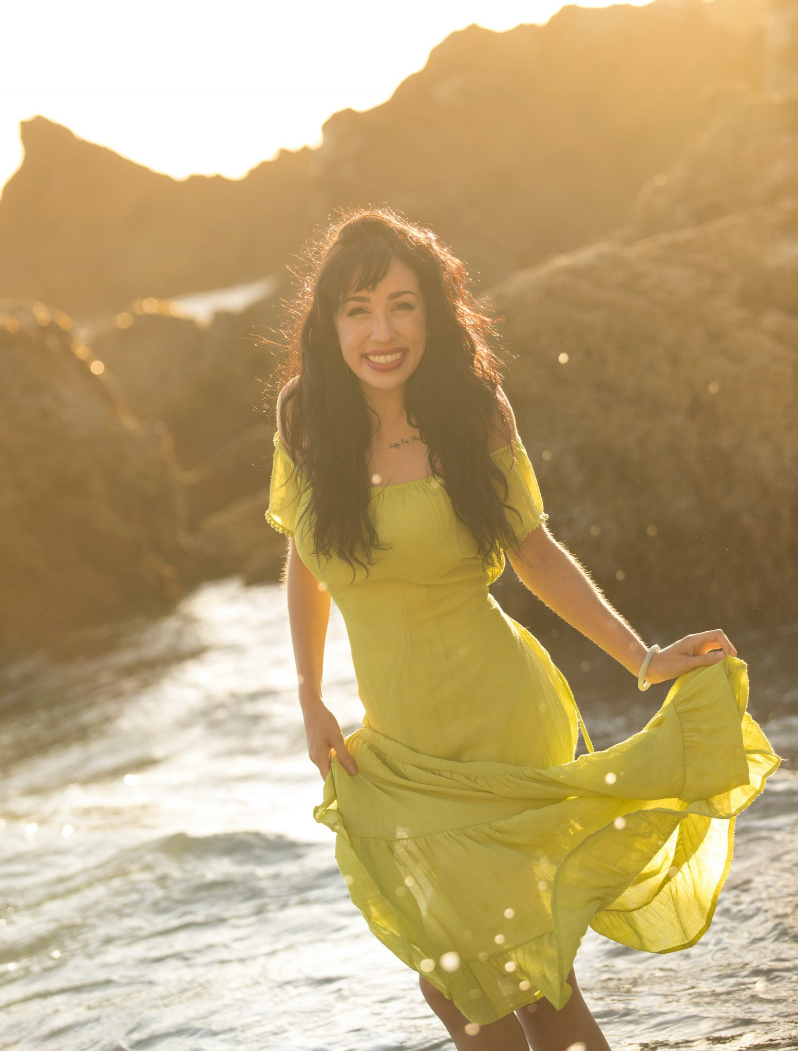 woman in yellow sleeveless dress standing on seashore during daytime